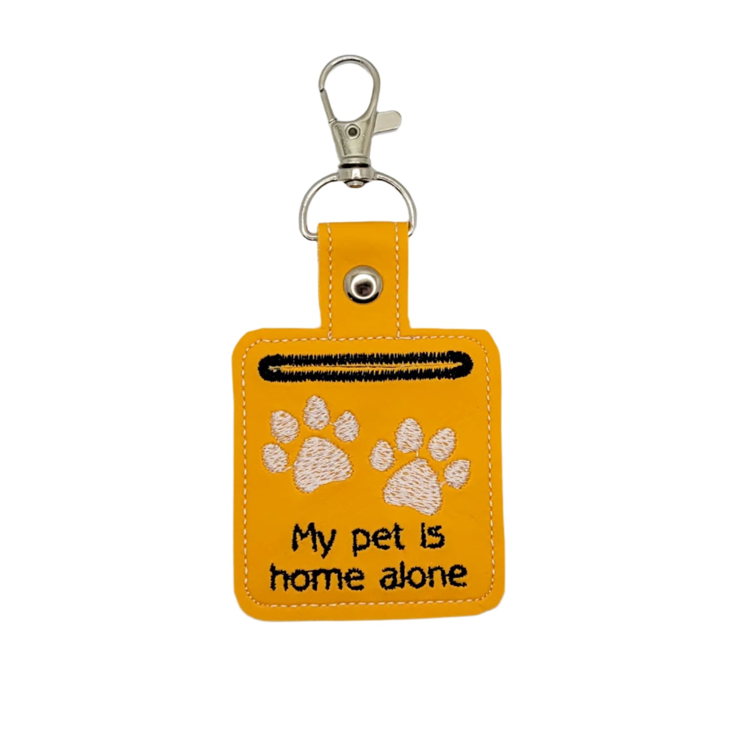 Yellow keychain with paw prints and text 'My pet is home alone' on a light gray background
