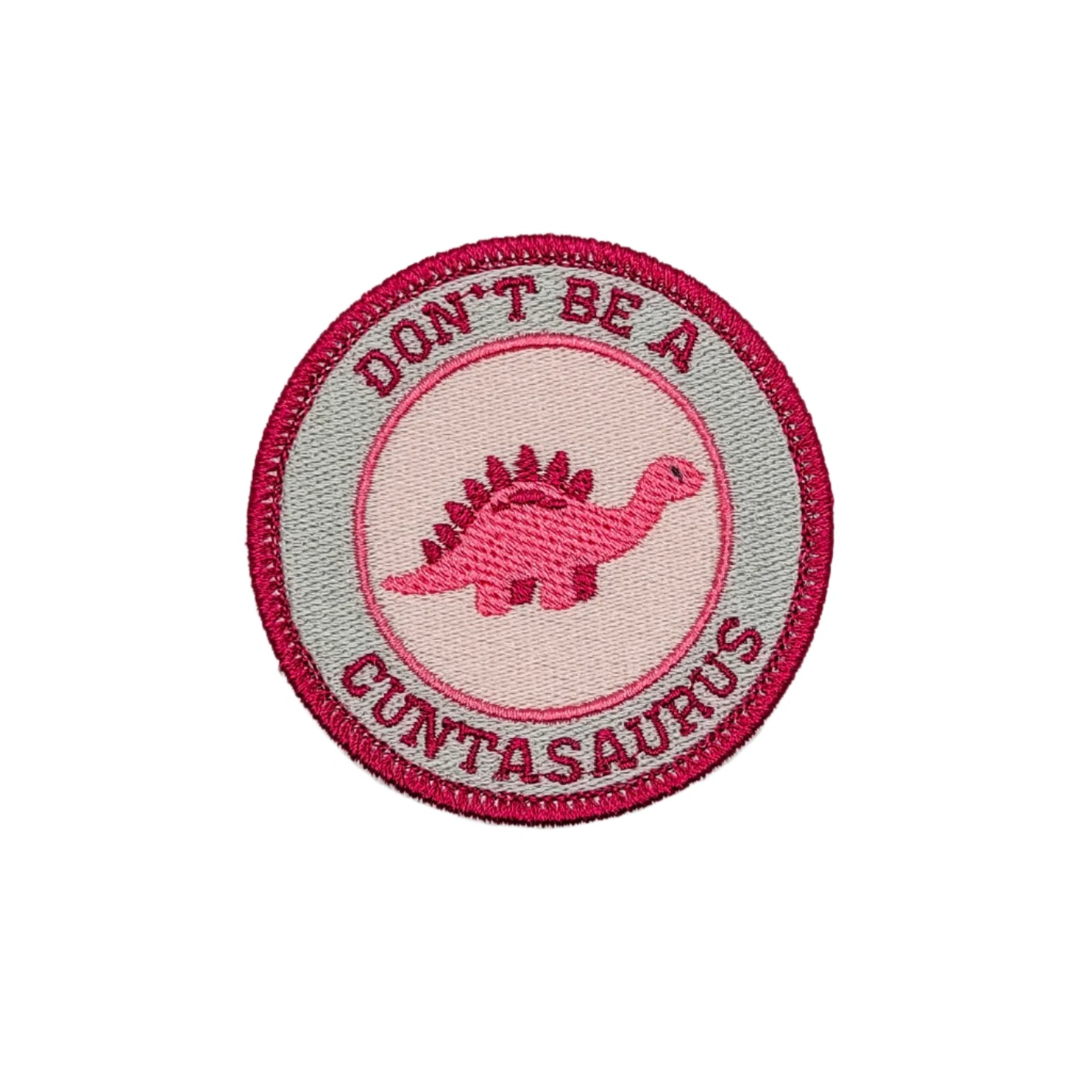 A collection of circular iron-on patches with the text 'DON'T BE A CUNTASAURUS' and a dinosaur motif in various colors.