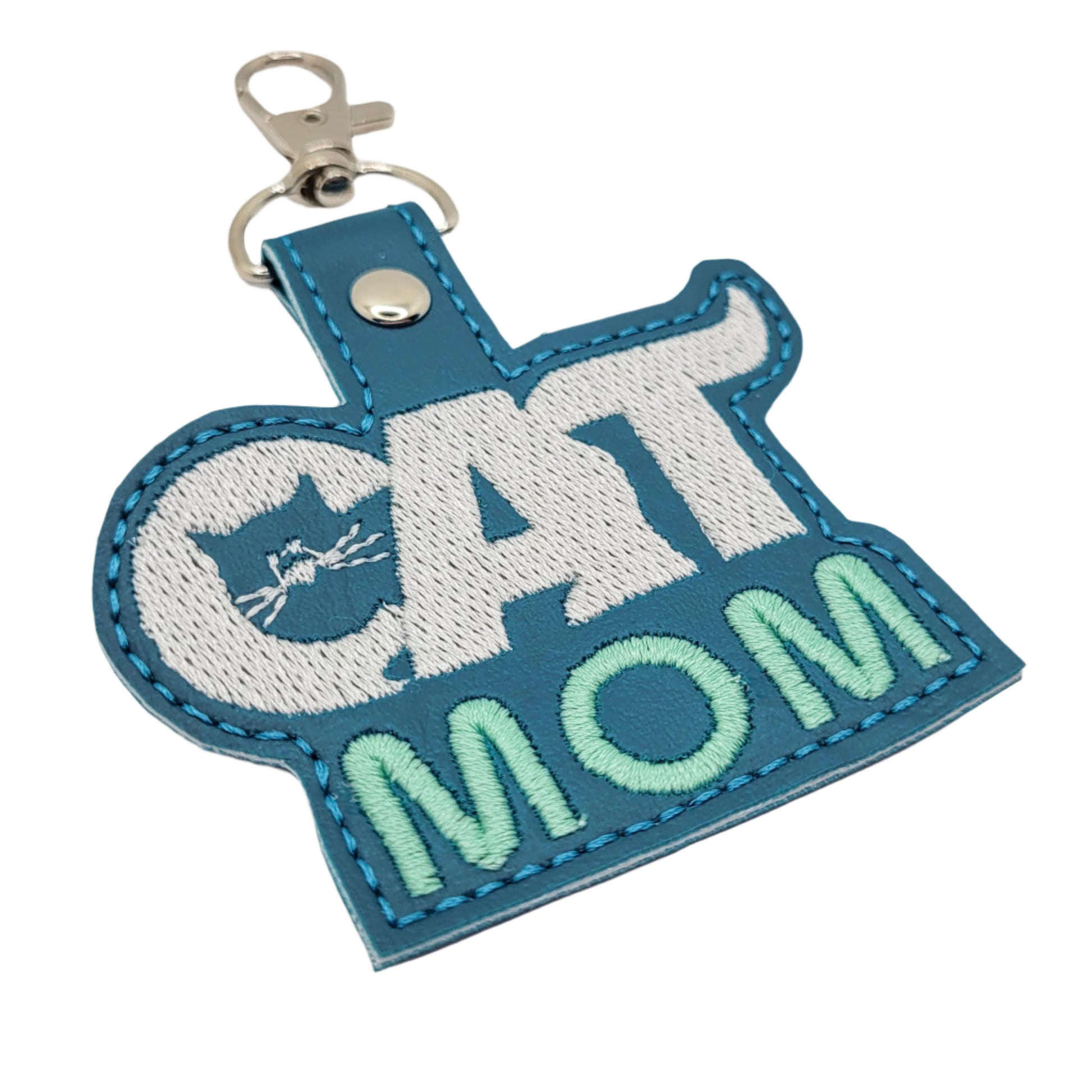 Keychain with 'CAT MOM' text on a light gray background