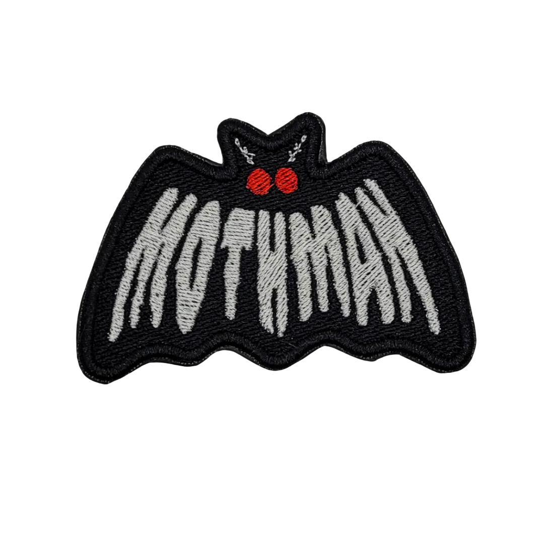 A black embroidered patch with the text 'MOTHMAN' and red eyes on a gray background.