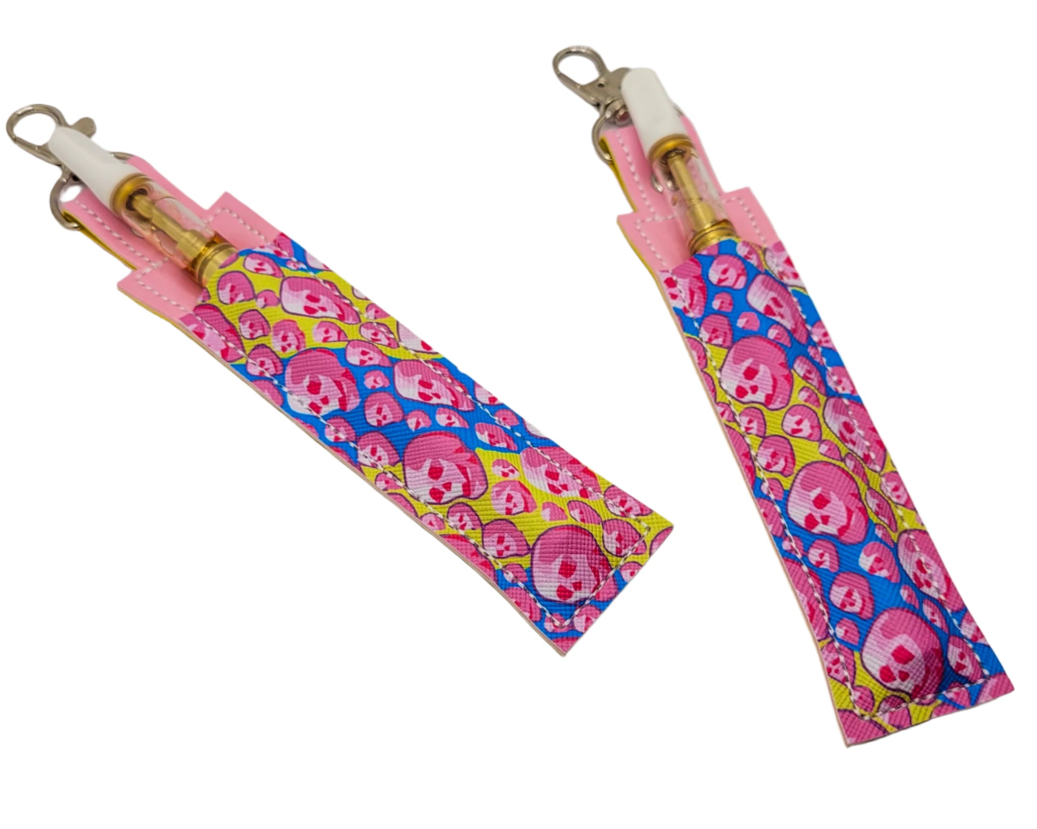 Pink and blue skull-patterned keychain and pen holder on a marble surface
