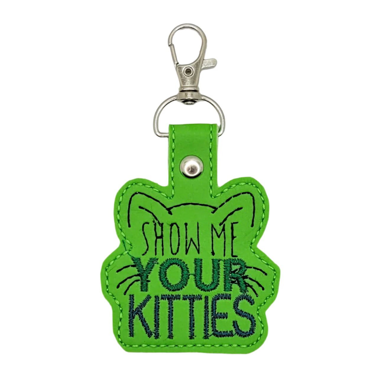 Green keychain with 'Show Me Your Kitties' text on a gray background