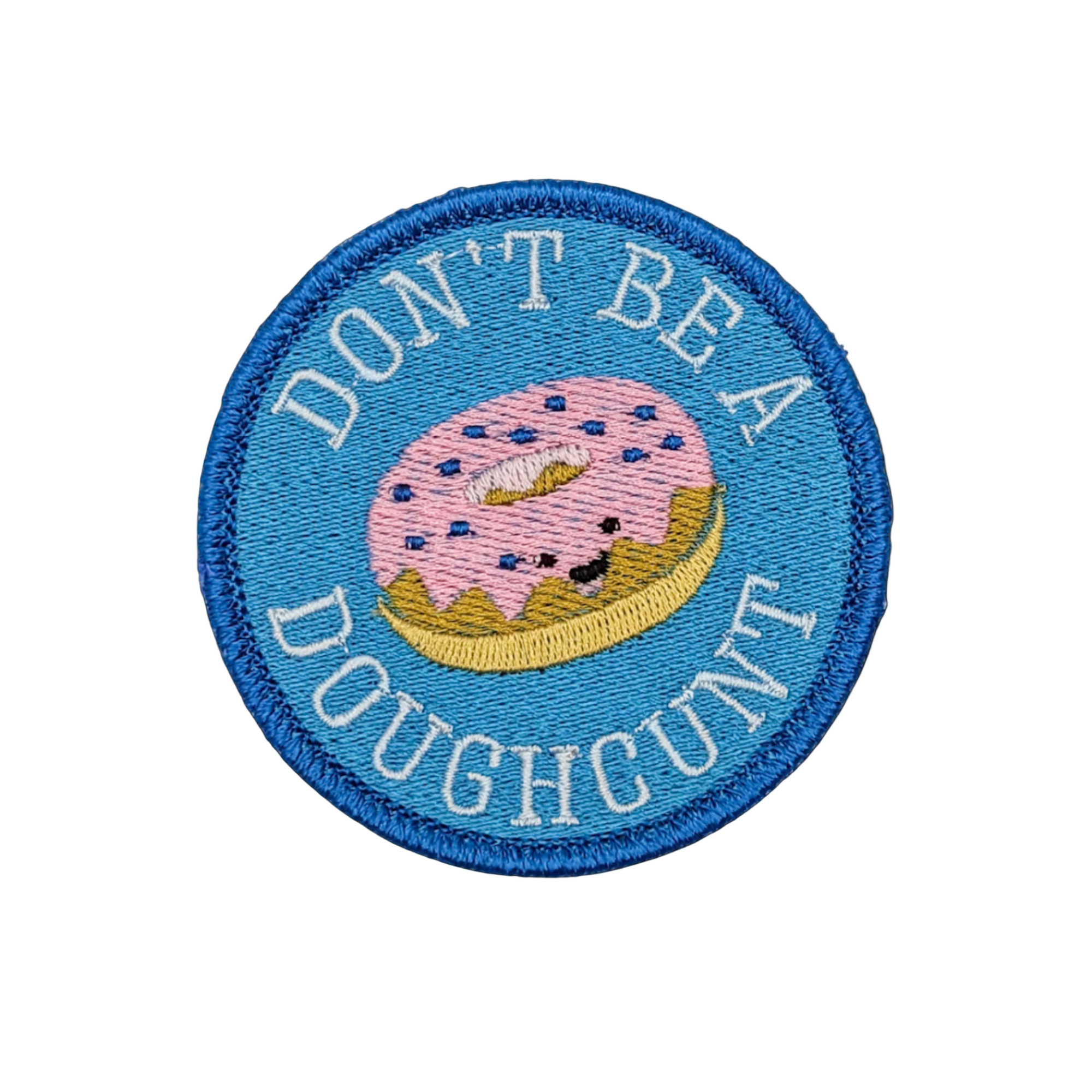 A round embroidered patch with a blue background, featuring a pink doughnut with the text 'DON'T BE A DOUGHCNT' below it.
