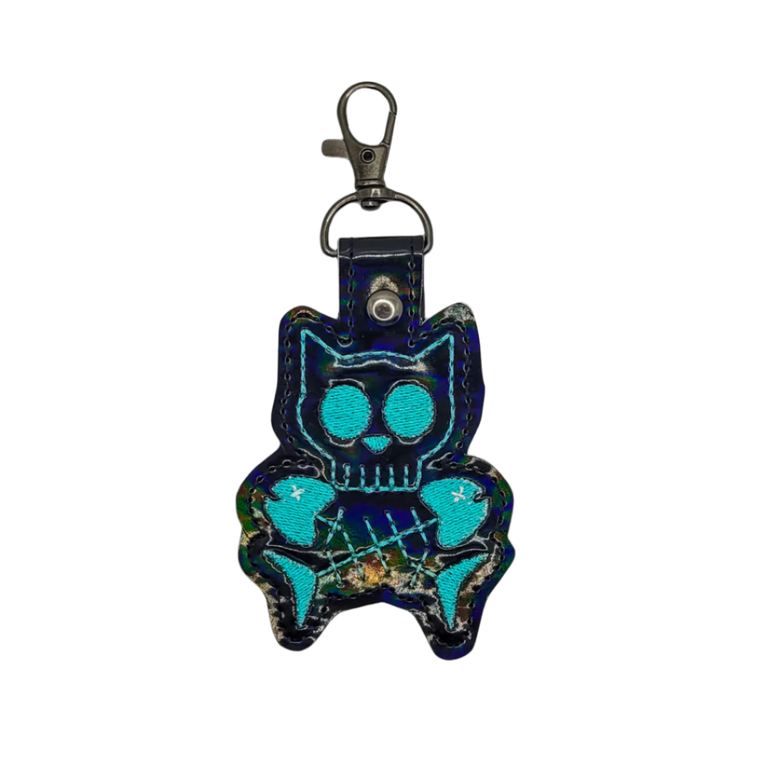 Blue cat-shaped keychain with a reflective surface on a white background