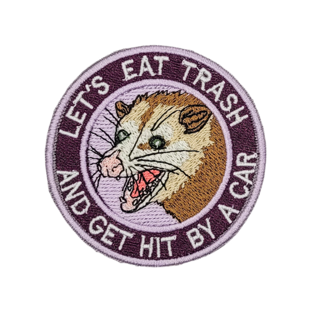 Embroidered patch with a rodent illustration and text on a marble surface