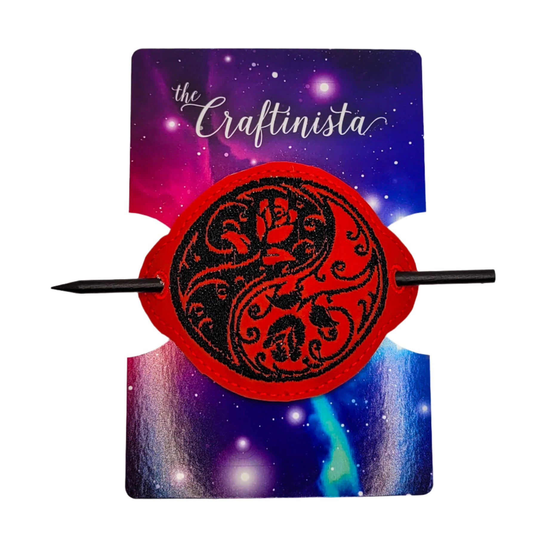 Embroidered bun cover with black floral yin yang design on red marine vinyl, secured with black wooden hair stick