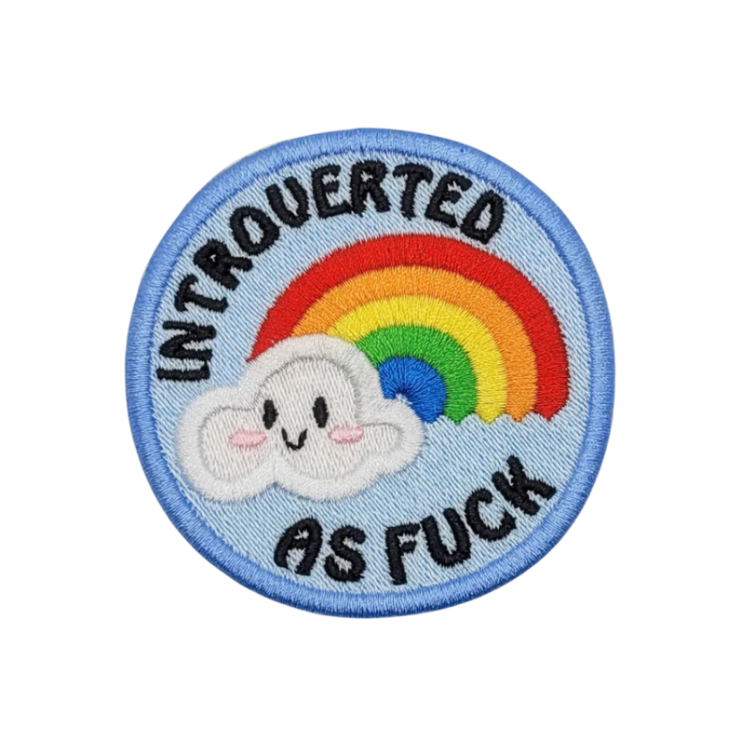 An embroidered patch featuring a smiling cloud, a vibrant rainbow, and the phrase 'Introverted AF'.