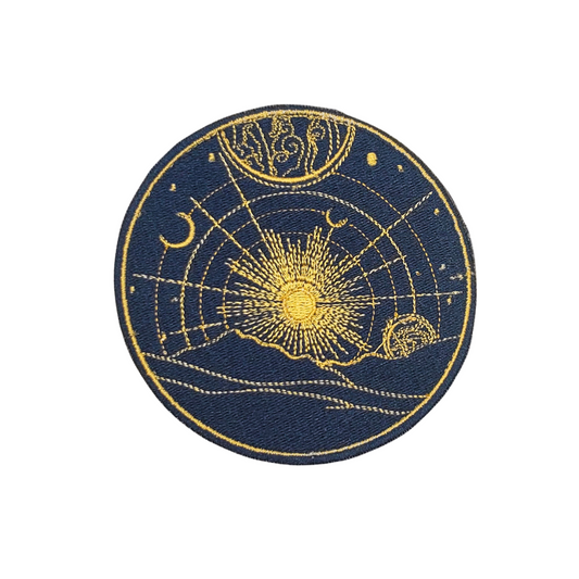 Circular patch with celestial design featuring sun, moon, and stars on a blue background
