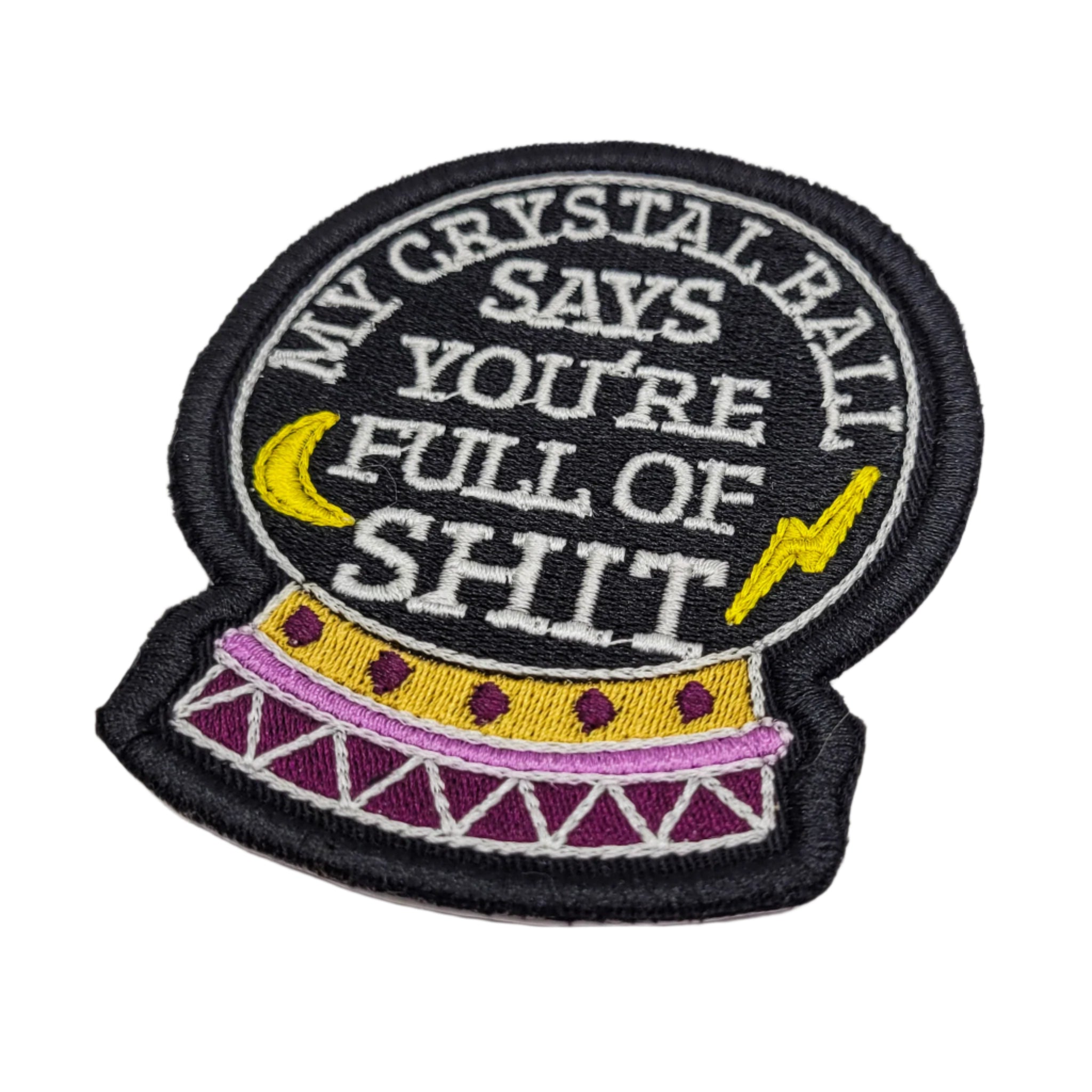 Embroidered patch with crystal ball design and text on a white background