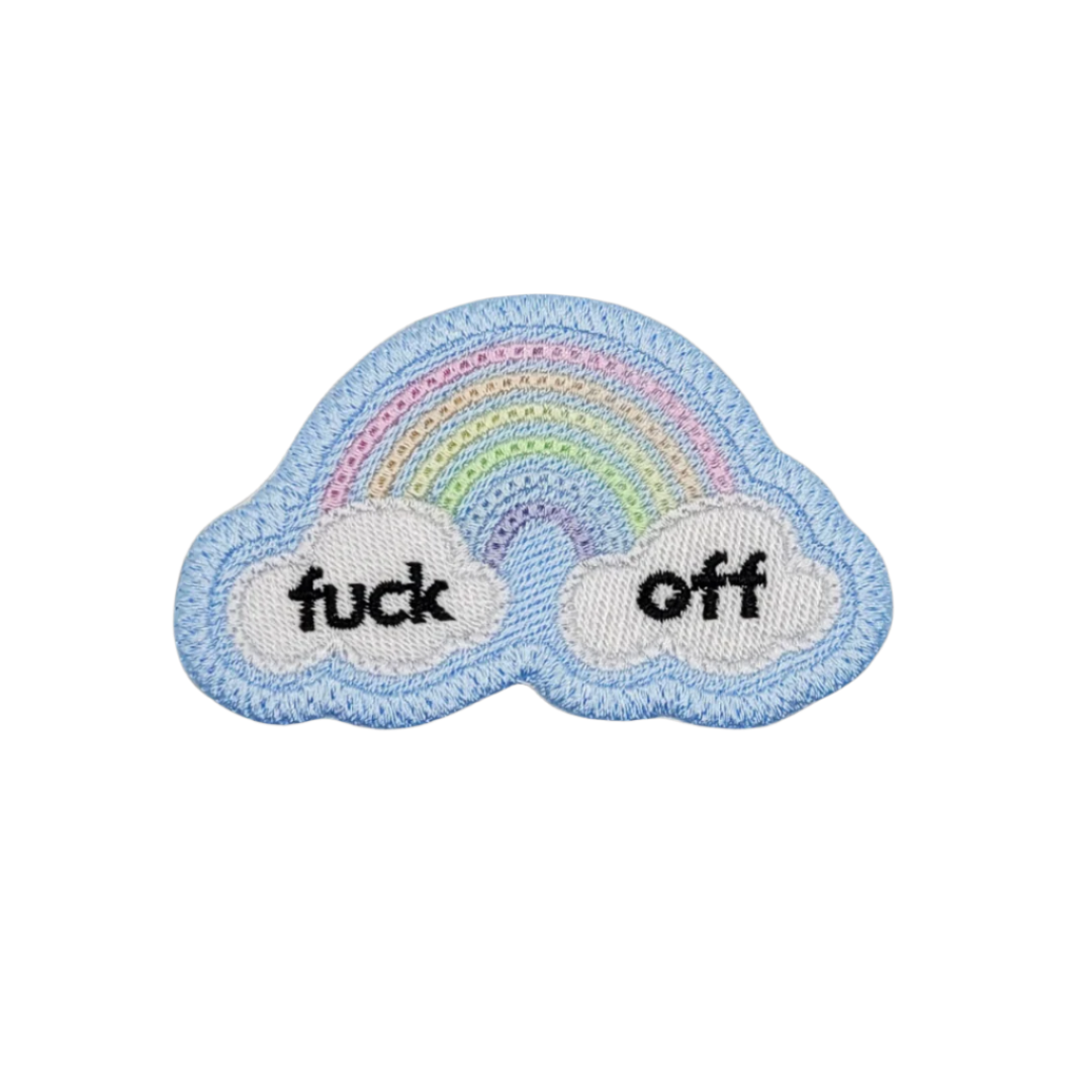 A blue embroidered patch with a rainbow and the text 'FUCK OFF' on a white background.