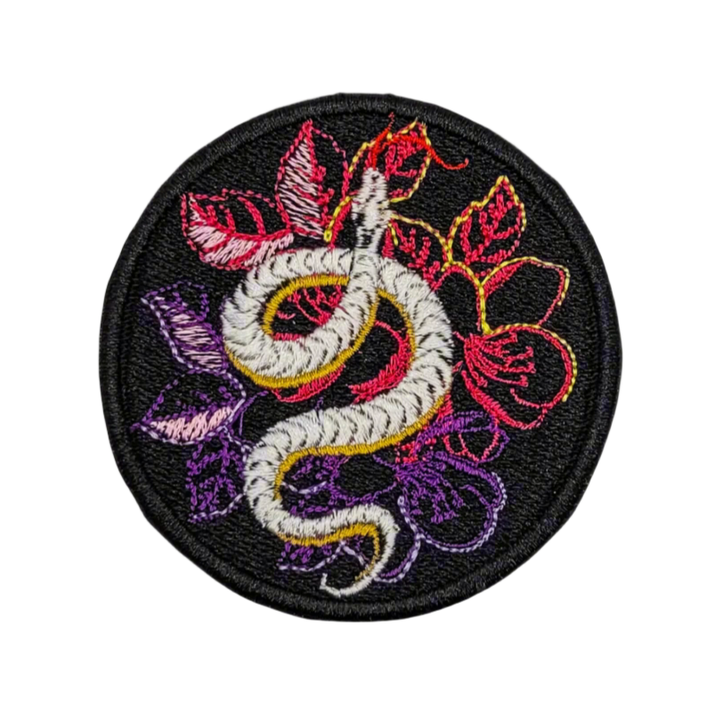 Embroidered patch with a snake and floral design on a black border