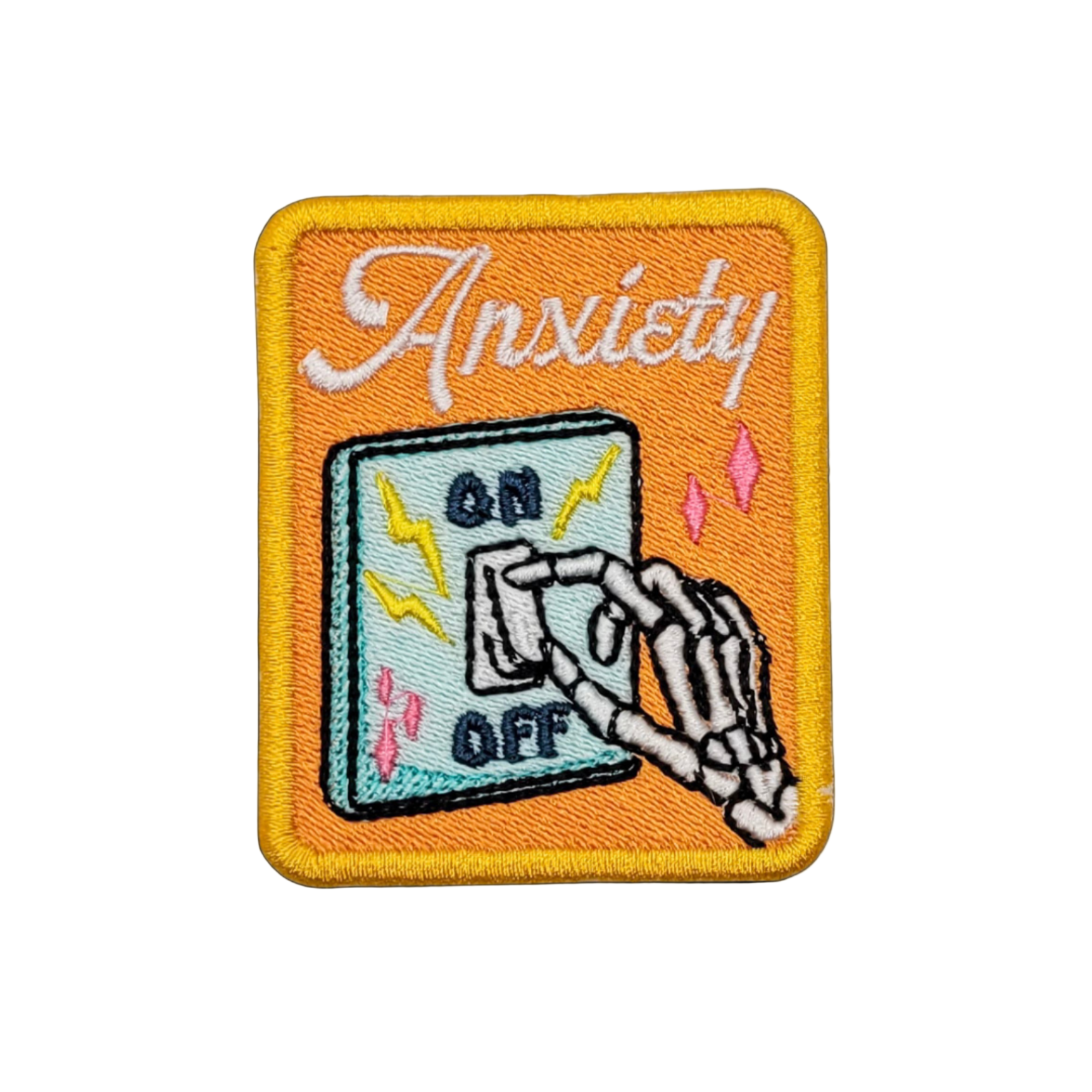 An embroidered patch featuring a skeleton hand flicking a light switch with the word 'Anxiety' above it.