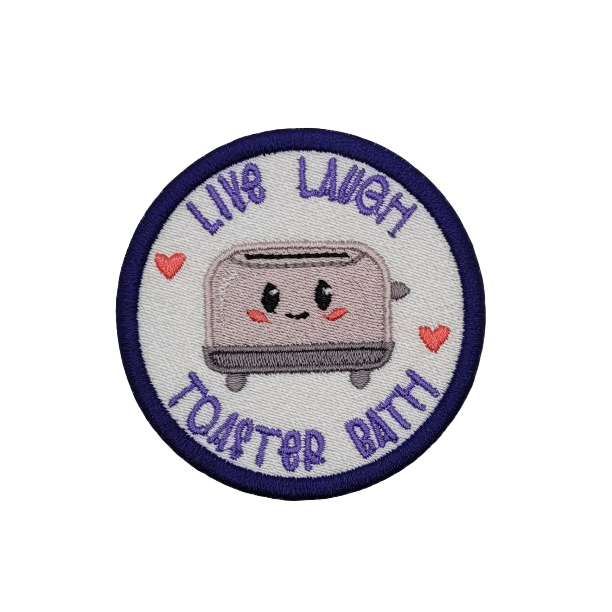 A circular embroidered patch featuring a cute toaster with the text 'Live Laugh Toaster Bath' and hearts, on a background that is white with a blue border.
