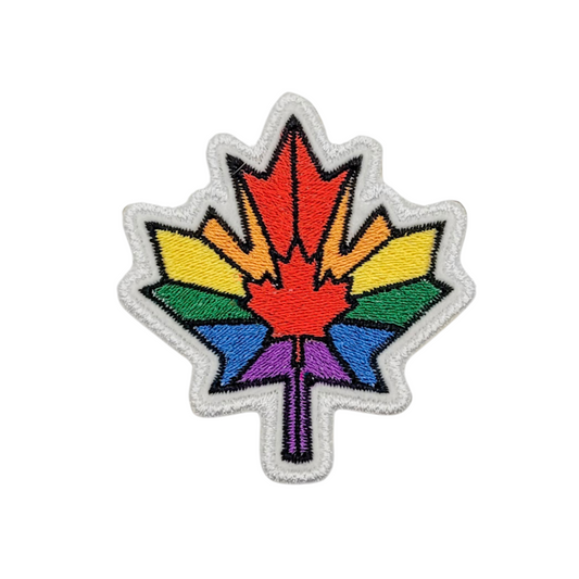 Close-up of the Rainbow Maple Leaf patch on a white background. The high-quality embroidery highlights vibrant red, orange, yellow, green, blue, and purple threadwork with a neatly finished white border.