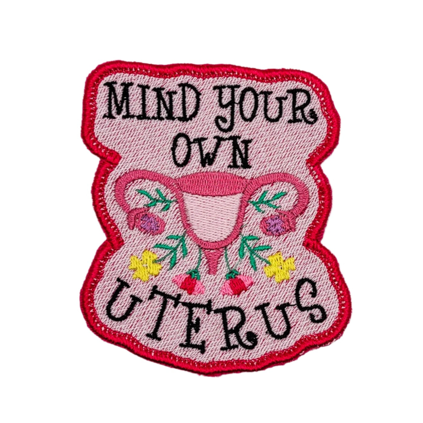 Embroidered patch with 'Mind your own uterus' text on a white background