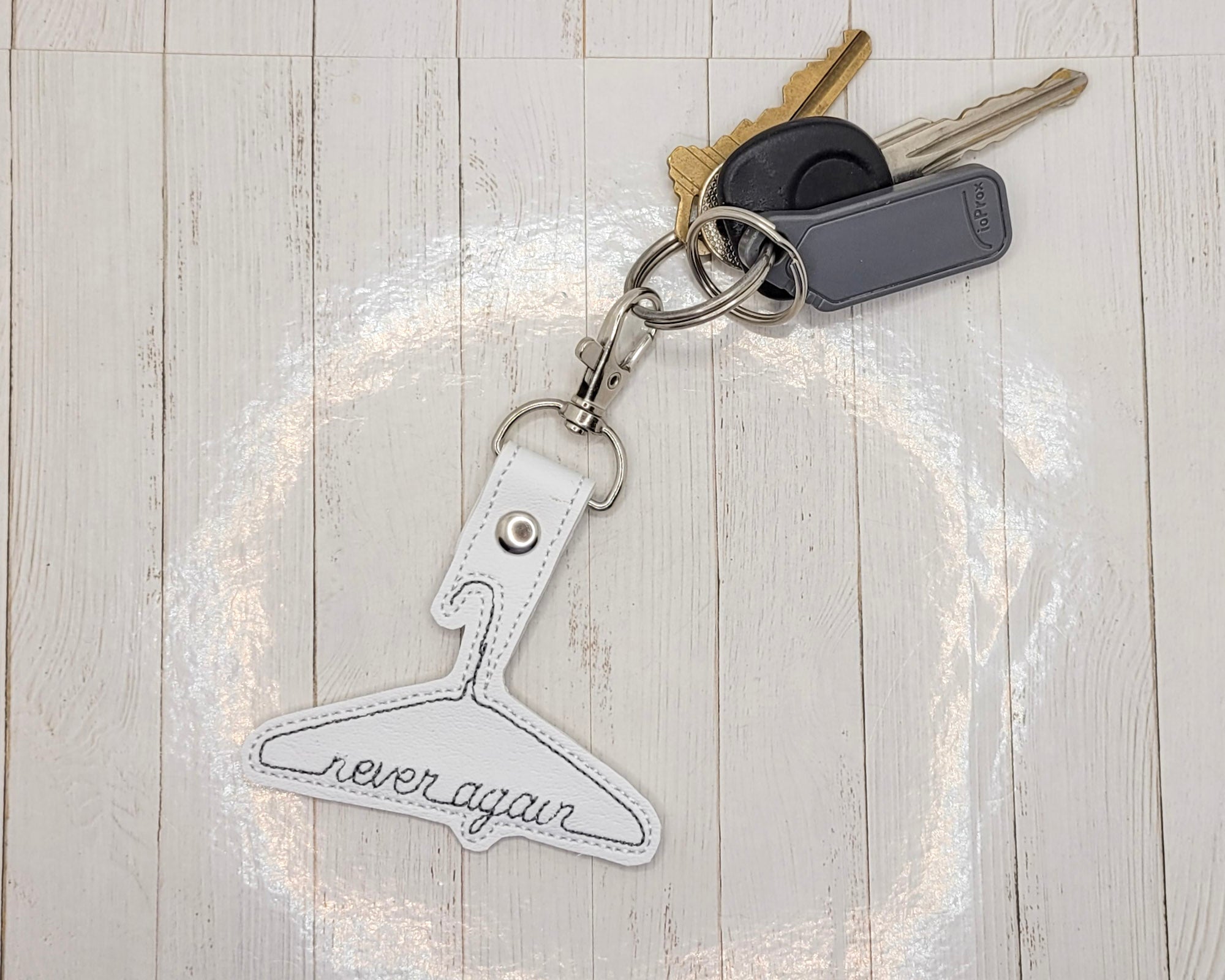 Never Again Metal Hanger Vinyl Embroidered Keychain