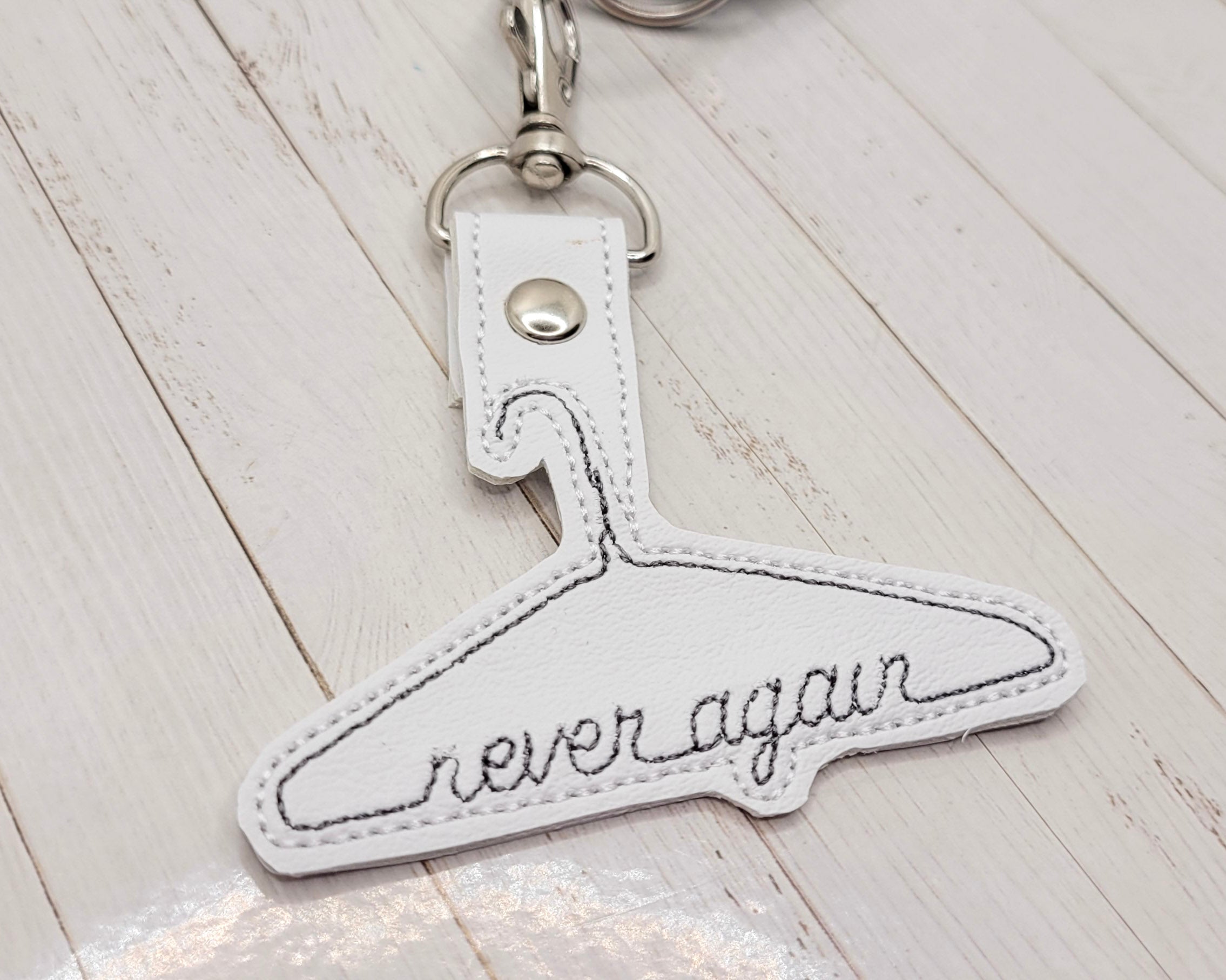 Never Again Metal Hanger Vinyl Embroidered Keychain