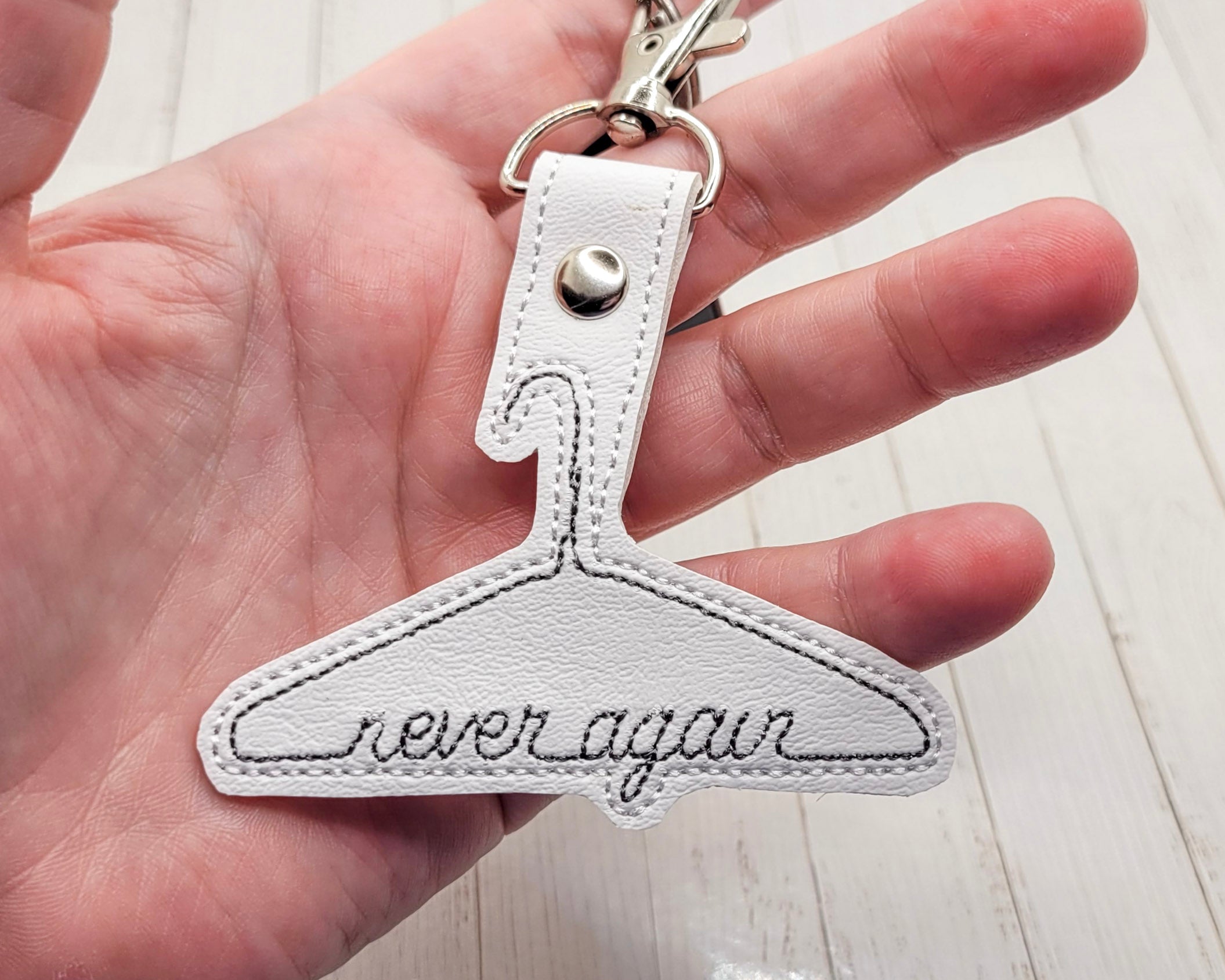 Never Again Metal Hanger Vinyl Embroidered Keychain