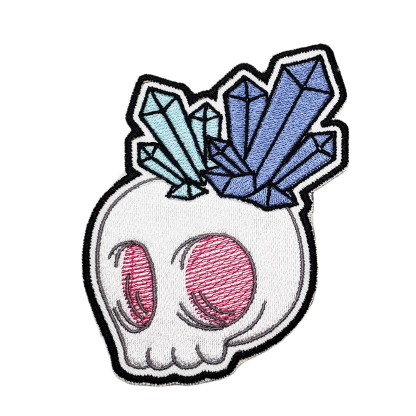 Patch of a skull with pink eyes and colorful crystals on a white background