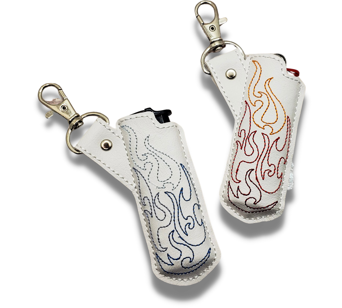 Two embroidered lighter cases with keychains, one white with blue flames embroidery and one red with orange flame designs.